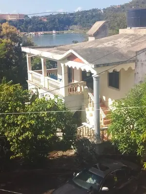 a white house with a view of the water at The Beauty of samana in Santa Bárbara de Samaná
