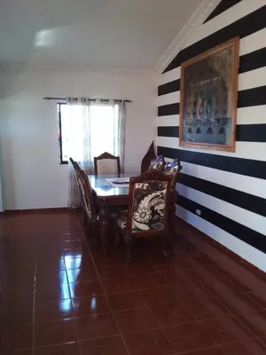 a dining room with black and white stripes on the wall at The Beauty of samana in Santa Bárbara de Samaná