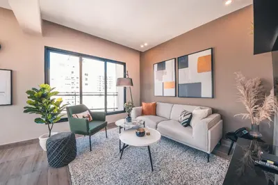 a living room with a couch and a table at Breakfast Included at Regatta Living 802 in Los Prados