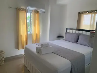 a bedroom with a bed with two towels on it at Plataview Apartahotel apt 4C in Monte Plata