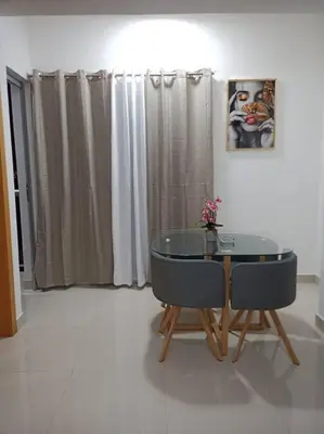 a dining room with a glass table and two chairs at El mejor apartamento cerca de la playa de Boca Chica in Boca Chica