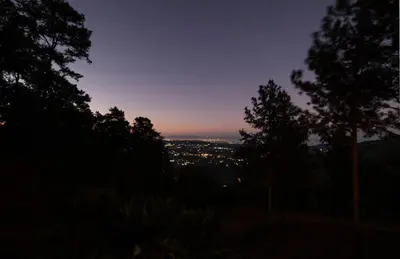 a view of a city at night with trees at NOMAD Domes at Salto Jimenoa, Jarabacoa in Jarabacoa
