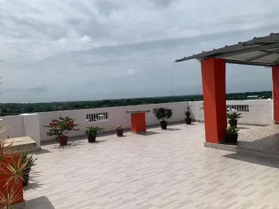 a patio with potted plants on top of a building at Plataview Apartahotel apt 3C in Monte Plata