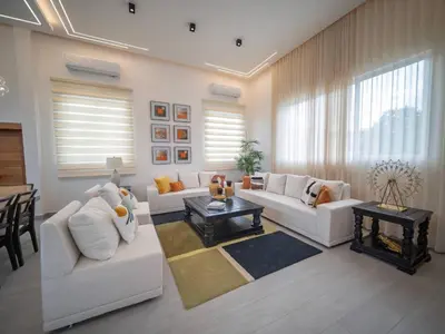 a living room with two white couches and a table at Luxurious Listed New Villa With 5 Br- 6 Bt In Sosua in Sosúa
