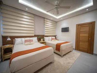 a bedroom with two beds and a ceiling fan at Luxurious Listed New Villa With 5 Br- 6 Bt In Sosua in Sosúa