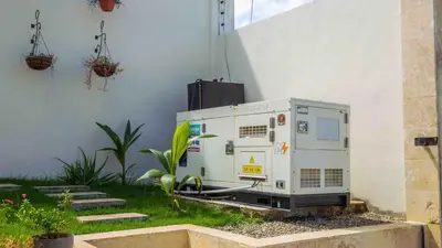 an appliance sitting on the grass next to a building at Luxurious Listed New Villa With 5 Br- 6 Bt In Sosua in Sosúa