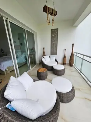 a living room with white furniture and vases at SEAWINDS CABARETE Front beach Condo in Cabarete