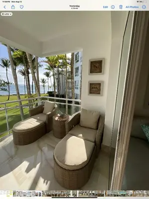 a living room with a couch and chairs on a balcony at SEAWINDS CABARETE Front beach Condo in Cabarete
