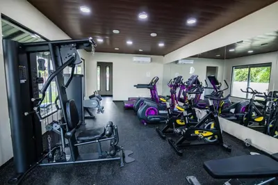 a gym with a bunch of exercise bikes in it at Breezes by TECASA in Santiago de los Caballeros