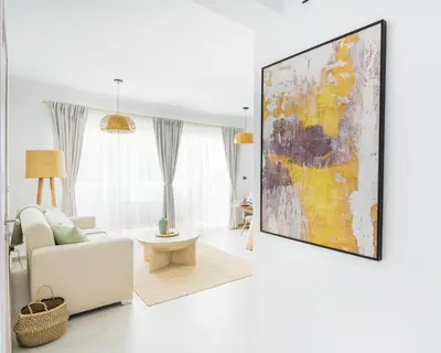 a living room with a large painting hanging on the wall at Estrella Dominicus Ekskluzywny Apartament ,,Bajeczny Widok,, in La Laguna