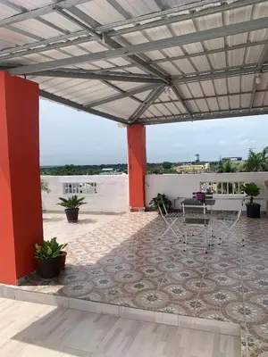 a patio with a table and chairs on a roof at Plataview Apartahotel apt 4A in Monte Plata