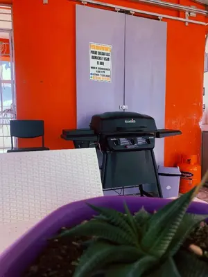 a grill in a room with an orange wall at Plataview Apartahotel apt 4A in Monte Plata