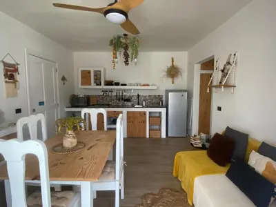 a kitchen and living room with a table and a couch at Portitxol, fantástico apartamento in Bayahibe