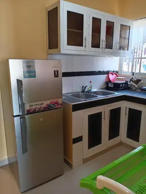 a kitchen with a refrigerator and a sink at Petite Lounge in Los Paredones