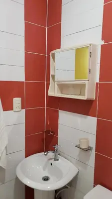 a bathroom with a sink and a mirror at Petite Lounge in Los Paredones