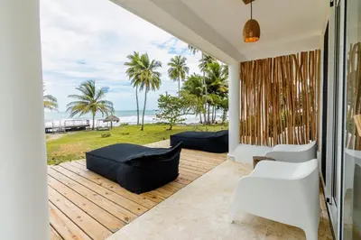 a living room with a view of the ocean at Surf and Yoga Retreat for Groups Near Cab! in Gaspar Hernández