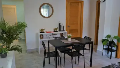 a dining room with a black table and chairs at La Yarolina in Punta Cana