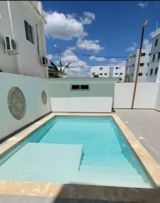 a swimming pool on the roof of a building at Chelsie 402 in Bayahibe