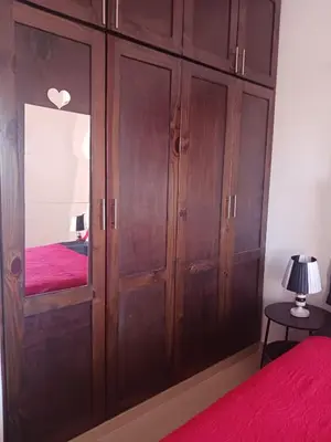 a bedroom with a large wooden cabinet with a mirror at Chelsie 402 in Bayahibe