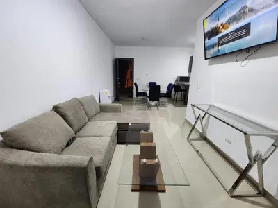 a living room with a couch and a tv at Chelsie 402 in Bayahibe