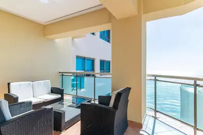 a room with chairs and a balcony with the ocean at Luxurious 2BDR with Ocean View in Santo Domingo