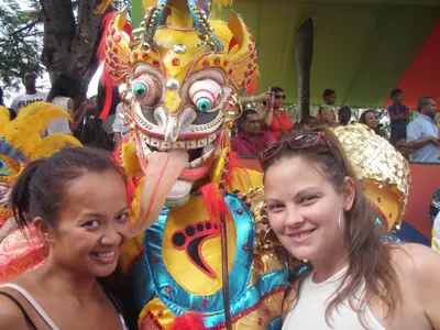 two women standing in front of a lion costume at Island Life Hostel in Santo Domingo