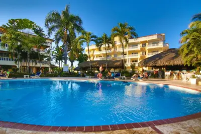 a large swimming pool in front of a hotel at Las Palmeras by Graziano in Boca Chica