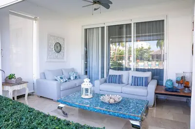 a living room with two couches and a table at Riviera Azul -2 Hab con vista a la Piscina - cash only or paypal in San Felipe de Puerto Plata