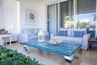 a living room with a couch and a table at Riviera Azul -2 Hab con vista a la Piscina - cash only or paypal in San Felipe de Puerto Plata