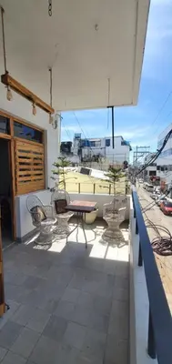 a patio with a table and chairs on a roof at Tus Recuerdos in Santo Domingo