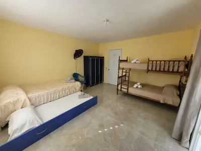 a bedroom with two beds and a crib at Marmota House in Santa Bárbara de Samaná