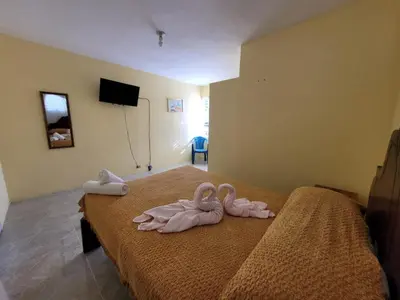 three towel animals sitting on top of a bed at Marmota House in Santa Bárbara de Samaná