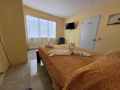 a hotel room with two beds with towels on them at Marmota House in Santa Bárbara de Samaná