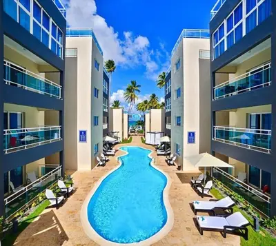 a swimming pool in the middle of a building at BeachFront Apartament - Private Beach Access in Punta Cana