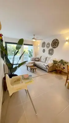 a living room with a couch and a table at Tropical Deluxe 2 Bedroom Unit with Picuzzi in Punta Cana