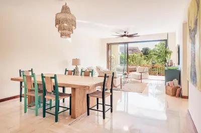 a dining room with a wooden table and chairs at Comfortable and charming apartment at Portillo WF in Las Terrenas