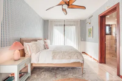 a bedroom with a bed and a ceiling fan at Comfortable and charming apartment at Portillo WF in Las Terrenas