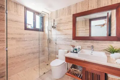 a bathroom with a toilet and a sink and a mirror at Comfortable and charming apartment at Portillo WF in Las Terrenas