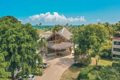 an aerial view of a resort with trees and the ocean at Comfortable and charming apartment at Portillo WF in Las Terrenas