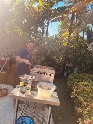a man standing next to a table with a box on it at Villa Clarissa No. 8 in Las Terrenas