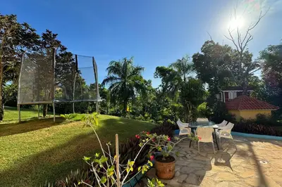 a patio with a table and chairs in a yard at Private Getaway - Sosua in Sosúa