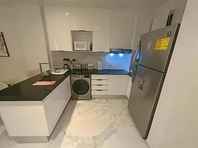 a kitchen with a refrigerator and a dishwasher at Cana Rock Star-Two apartments very close-Ground floor direct access to the pool in Punta Cana