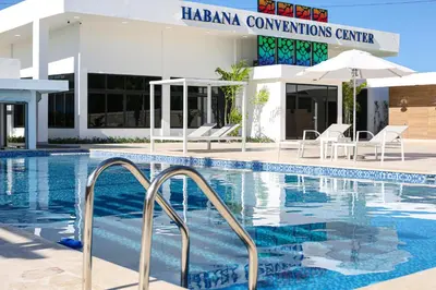 a swimming pool in front of a hotel at Habana Hotel Y Restaurante in Higuey