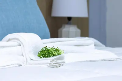 a pile of towels sitting on top of a bed at Habana Hotel Y Restaurante in Higuey