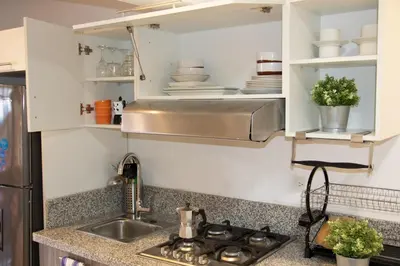 a kitchen with white cabinets and a sink at Casa de Nini in Santo Domingo
