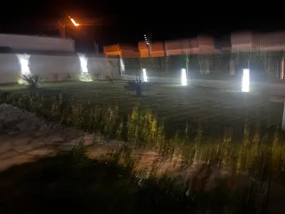 a garden at night with lights in a building at villa green paradise in San Felipe de Puerto Plata
