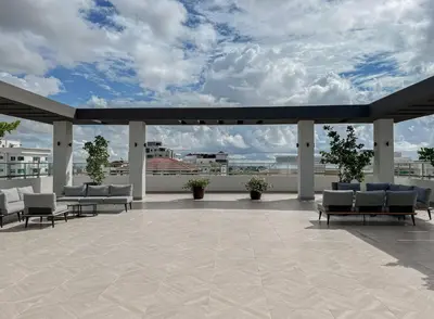 a rooftop patio with chairs and a sky at Goistay Elegant Refugio Caribeo 1br Gym Pool Naco in Santo Domingo
