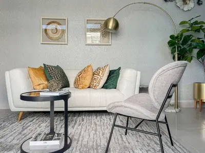 a living room with a couch and a table and a chair at Goistay Elegant Refugio Caribeo 1br Gym Pool Naco in Santo Domingo