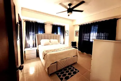 a bedroom with a bed and a ceiling fan at Goistay Descubre el Encanto nico de Repblica Dominicana Bella Vista in Los Prados