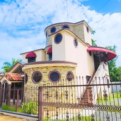a building with a fence in front of it at Villa lujosa con piscina bayaguana in Bayaguana